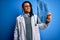 Young african american afro doctor man with dreadlocks holding chest lung xray with a happy face standing and smiling with a