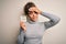 Young african american afro girl holding reminder paper with pay taxes message stressed with hand on head, shocked with shame and