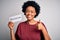 Young African American afro politician woman with curly hair socialist party member happy with big smile doing ok sign, thumb up