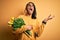 Young african american afro romantic man with dreadlocks holding bouquet of yellow tulips crazy and mad shouting and yelling with