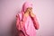 Young African American afro woman wearing muslim hijab over isolated pink background rubbing eyes for fatigue and headache, sleepy