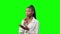 Young African American Black Woman with smartphone thinking on a green background