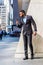 Young African American Businessman with beard self recording speech on cell phone outside office building in New York City