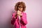 Young african american businesswoman wearing glasses standing over pink background Ready to fight with fist defense gesture, angry