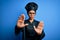 Young african american chef woman wearing cooker uniform and hat over blue background doing stop gesture with hands palms, angry