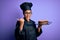 Young african american cooker girl wearing uniform and hat holding tray with cake pointing and showing with thumb up to the side