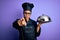 Young african american cooker girl wearing uniform and hat holding tray with dome pointing with finger to the camera and to you,