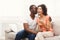 Young african-american couple happy about results of pregnancy test