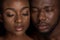 young african american couple with water drops on faces posing with closed eyes