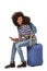 Young african american female traveler sitting on suitcase with mobile phone