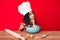 Young african american girl child with braids cooking using baker whisk serious face thinking about question with hand on chin,