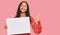 Young african american girl holding blank empty banner smiling happy and positive, thumb up doing excellent and approval sign