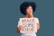 Young african american girl holding make some noise banner serious face thinking about question with hand on chin, thoughtful