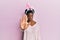 Young african american girl wearing cute easter bunny ears doing stop sing with palm of the hand