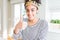 Young african american girl wearing golden queen crown on head doing happy thumbs up gesture with hand