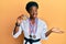 Young african american girl wearing karate kimono and black belt celebrating achievement with happy smile and winner expression