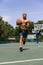 Young african-american male basketball player training at street public stadium, sport court or palyground outdoors