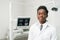 Young African American male doctor dentist in dental office. Medicine, health, stomatology concept. Looking into the