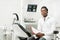 Young African American male doctor dentist in dental office. Medicine, health, stomatology concept. Looking into the