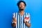 Young african american man with beard eating strawberry ice cream looking at the camera blowing a kiss being lovely and sexy