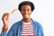 Young african american man eating nigiri using chopsticks over isolated white background with a happy face standing and smiling