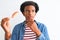 Young african american man eating nigiri using chopsticks over isolated white background serious face thinking about question,