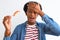 Young african american man eating nigiri using chopsticks over isolated white background stressed with hand on head, shocked with