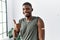 Young african american man getting vaccine showing arm with band aid smiling happy and positive, thumb up doing excellent and