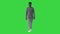 Young african american man in grey casual clothes walking towards camera on a Green Screen, Chroma Key.