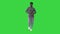 Young african american man in grey clothes and glasses grooving while walking on a Green Screen, Chroma Key.