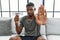 Young african american man holding diet banner sitting on the sofa at home with open hand doing stop sign with serious and