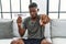 Young african american man holding diet banner sitting on the sofa at home pointing with finger to the camera and to you,