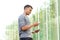 Young african american man holding external battery and cellphone