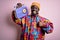 Young african american man listening to music holding portable vintage retro radio happy with big smile doing ok sign, thumb up