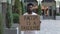 Young African American man stands with a cardboard poster RACISM IS A PANDEMIC in public outdoor place. An anti racist