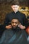 Young African-american man visiting barbershop