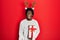 Young african american man wearing deer christmas hat holding gift angry and mad screaming frustrated and furious, shouting with