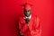 Young african american man wearing graduation cap and ceremony robe looking at the camera blowing a kiss with hand on air being