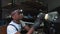 A young African American man works at work. Polishing car headlights. A man uses a special device to restore the