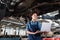 young african american mechanic standing underneath