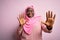 Young african american plus size woman wearing muslim hijab over isolated pink background afraid and terrified with fear