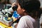 Young African American Schoolgirl is Studying Electronics and Soldering Wires and Circuit Boards in Her Science Hobby