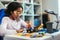 Young African American Schoolgirl is Studying Electronics and Soldering Wires and Circuit Boards in Her Science Hobby