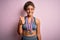 Young african american sporty girl doing sport winning medals over isolated pink background doing happy thumbs up gesture with