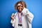 Young african american sporty woman with curly hair doing sport winning medals with happy face smiling doing ok sign with hand on