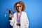 Young african american sporty woman doing sport winning medals and trophy with a happy face standing and smiling with a confident