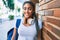 Young african american student woman smiling happy leaning on the wall at the university campus