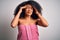 Young african american woman with afro hair wearing a body towel after beauty care shower suffering from headache desperate and