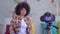 Young African American woman with Afro hairstyle blogger writes video in the living room slow mo
