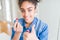 Young african american woman applying red lipstick on lips happy with big smile doing ok sign, thumb up with fingers, excellent